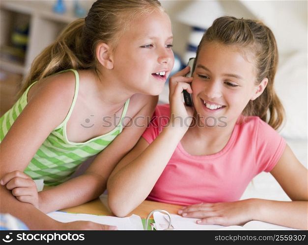 Young Girls Distracted From Their Homework, Talking On A Cellphone