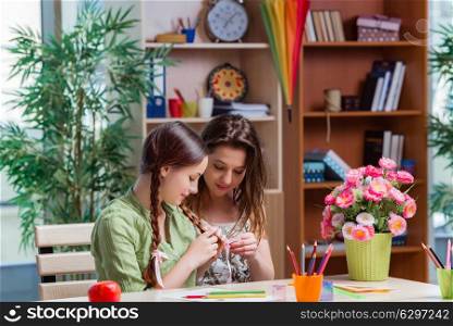 Young girls drawing pictures at home