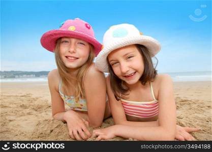 Young girls laying down at the beach