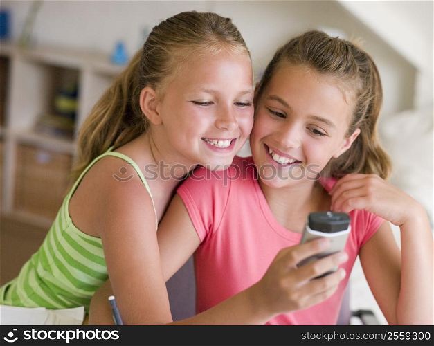 Young Girls Playing With A Cellphone