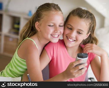 Young Girls Playing With A Cellphone