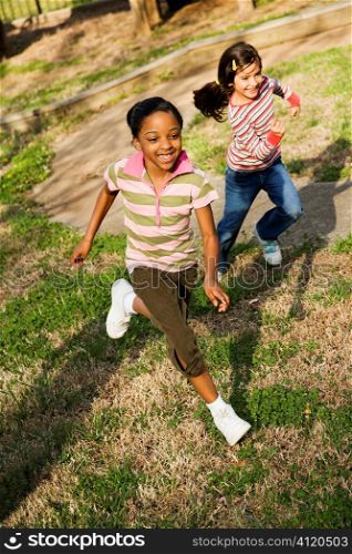 Young Girls Running on Grass
