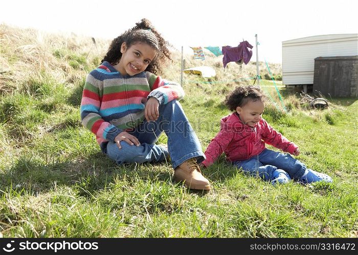 Young Girls Sitting Outside In Caravan Park