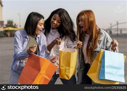 young girls taking walk after shopping outdoors