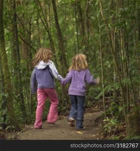 Young girls walking through forest in Costa Rica