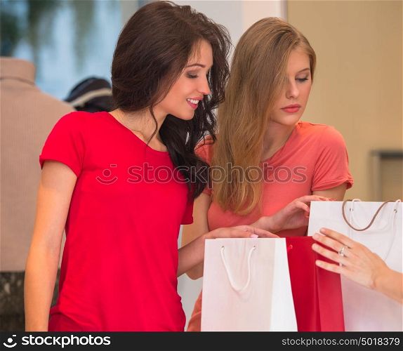 Young girls with shopping bags in store