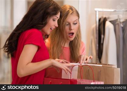 Young girls with shopping bags in store