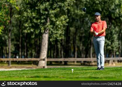 Young golfer getting ready to play from a tee box