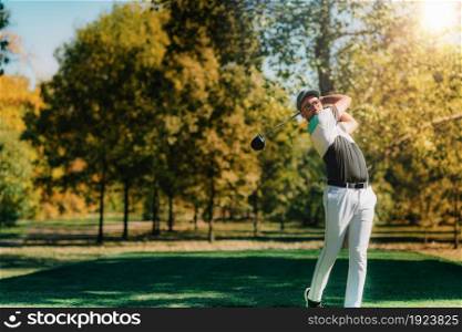 Young golfer hitting the ball