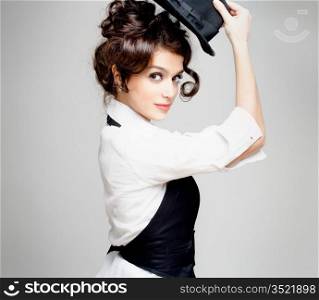 young gorgeous brunette posing with hat, studio shot