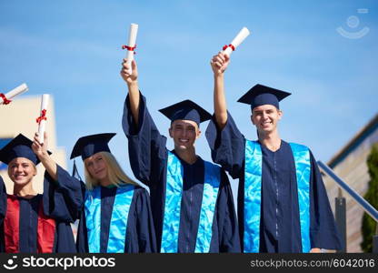 young graduates students group standing in front of university building on graduation day