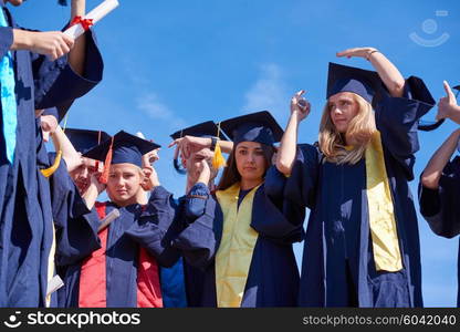 young graduates students group standing in front of university building on graduation day