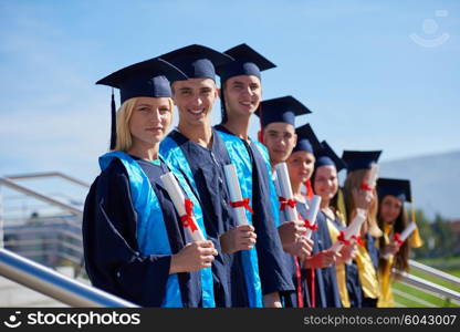 young graduates students group standing in front of university building on graduation day