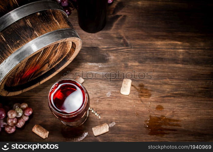 Young grape wine in a glass on the table. On a wooden background. . Young grape wine in a glass on the table.