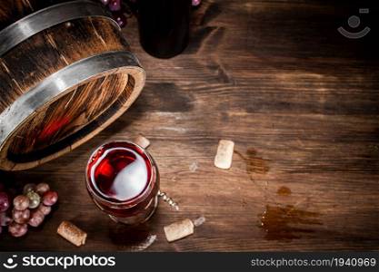 Young grape wine in a glass on the table. On a wooden background. . Young grape wine in a glass on the table.