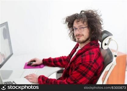 young graphic designer in bathrobe working at home office using computer