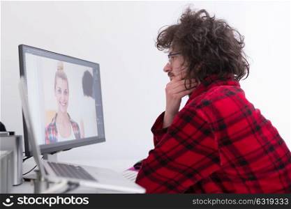 young graphic designer in bathrobe working at home office using computer