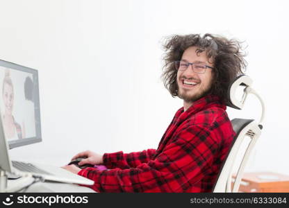 young graphic designer in bathrobe working at home office using computer