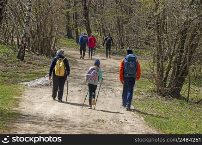 Young Group of people walking by hiking trail 