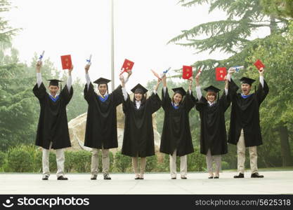 Young Group of University Graduates With Diplomas in Hand