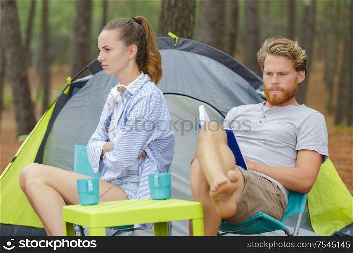 young grumpy couple on camping