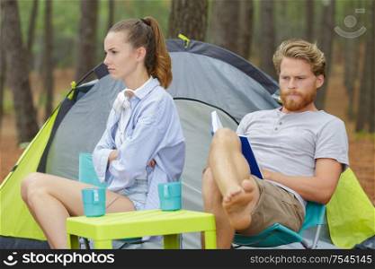 young grumpy couple on camping