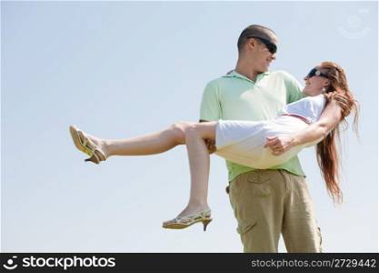 Young Guy Carrying His Girlfriend In His Arms, Outdoor