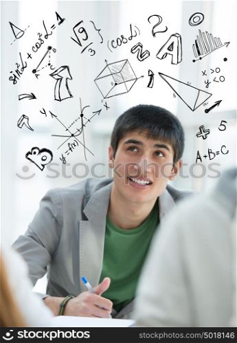 Young guy student at school with math symbols overhead. Education concept