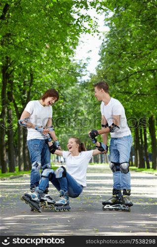 Young guys raise the fallen girl on roller skates