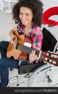young handicapped woman holding a guitar