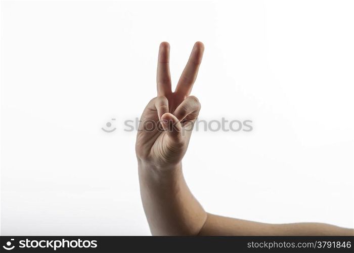 Young hands make a 2 fingers gesture