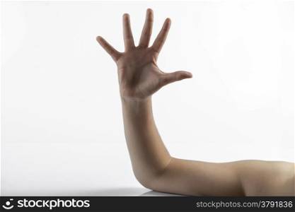 Young hands make a five fingers gesture