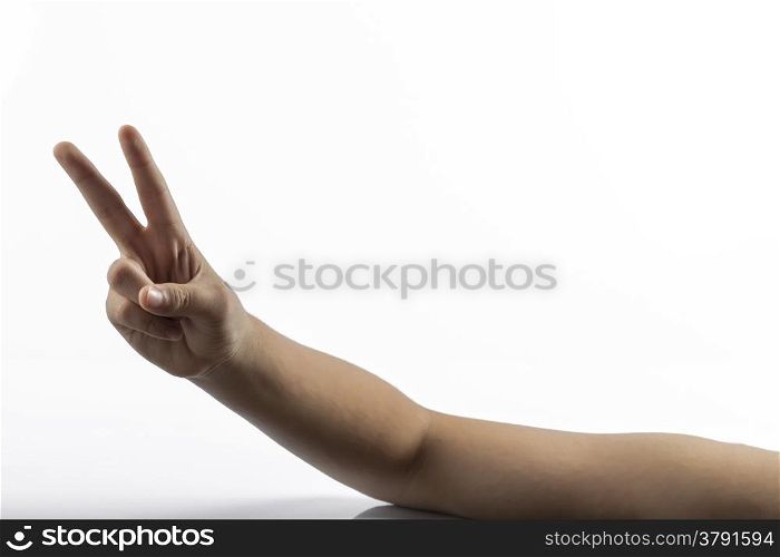 Young hands makes a gesture: victory sign with two fingers