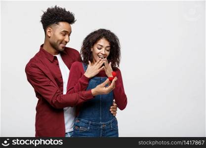 Young handsome african american man surprisingly ask her girlfriend for proposal.. Young handsome african american man surprisingly ask her girlfriend for proposal