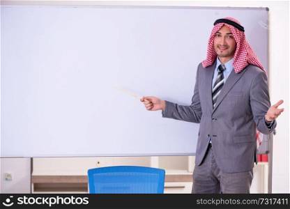 Young handsome arab teacher wearing suit 
