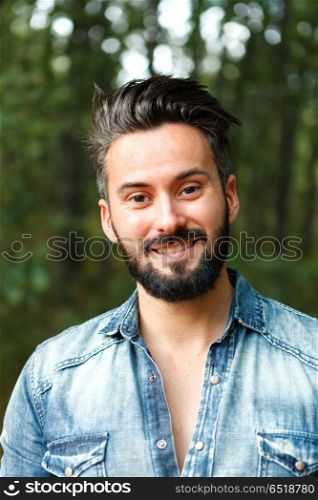 Young handsome bearded hipster man. Young handsome bearded hipster man in the field