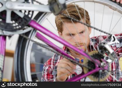 young handsome bicycle repairman