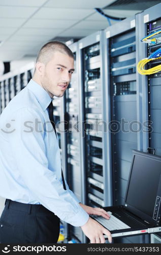 young handsome business man engeneer in datacenter server room