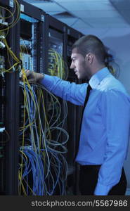 young handsome business man engeneer in datacenter server room