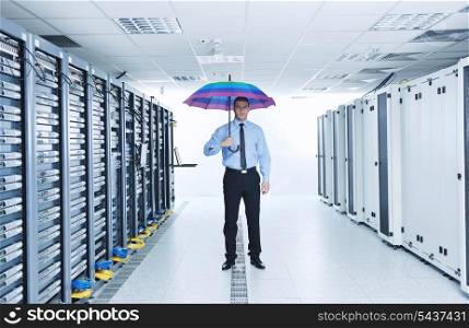 young handsome business man engineer in &#xA;businessman hold rainbow colored umbrella in server datacenter room and representing security and antivirus sofware protection concept