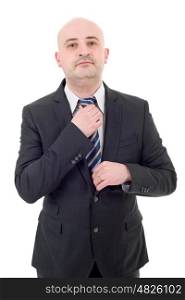 Young handsome businessman adjusts his tie, isolated