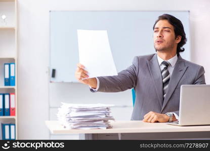 Young handsome businessman employee in the office 