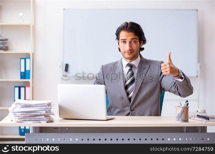 Young handsome businessman employee in the office 