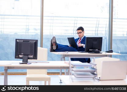 Young handsome businessman employee working in office at desk