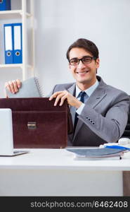 Young handsome businessman employee working in office at desk