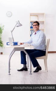 Young handsome businessman employee working in office at desk