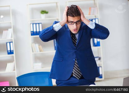 Young handsome businessman employee working in office at desk