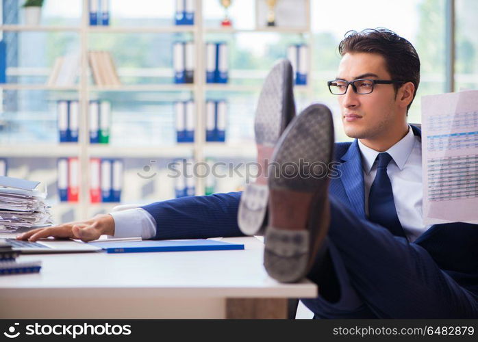 Young handsome businessman employee working in office at desk