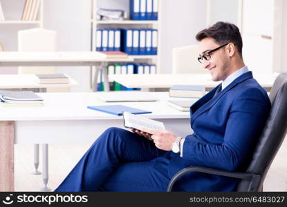 Young handsome businessman employee working in office at desk