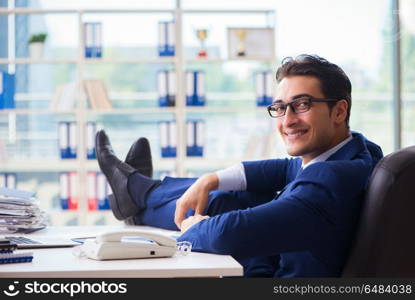 Young handsome businessman employee working in office at desk